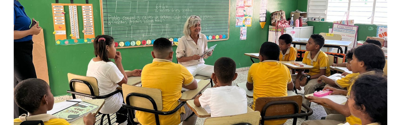 An instructor is giving directions to students. The students are attentive and looking at the instructor.
